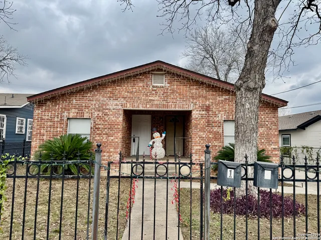 a front view of a house with yard and outdoor seating