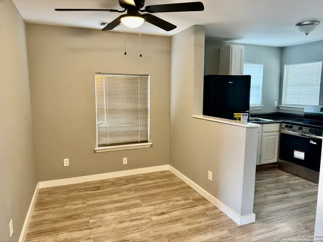 a view of a kitchen with microwave and cabinets