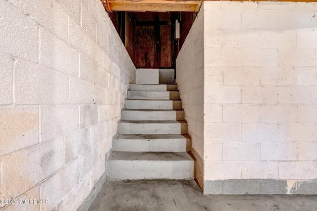 a view of an empty room with stairs