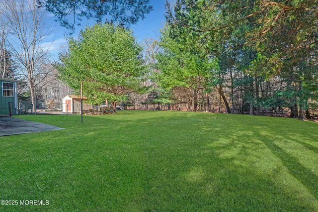 a big house with a big yard and large trees