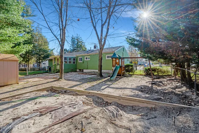 a view of a backyard with large trees and plants