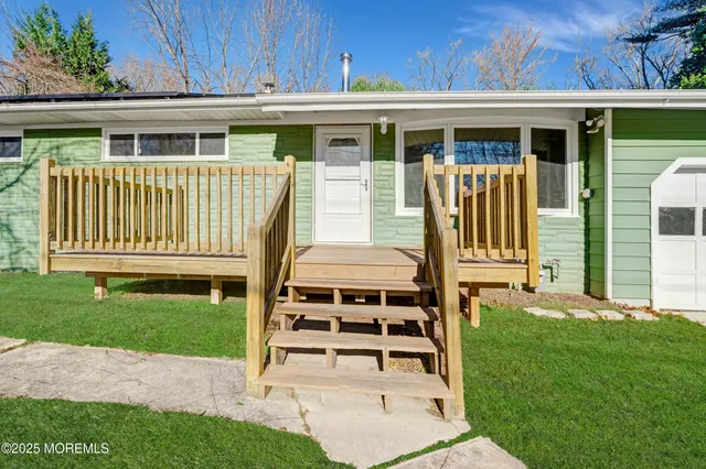 a view of a bedroom with wooden floor and a window