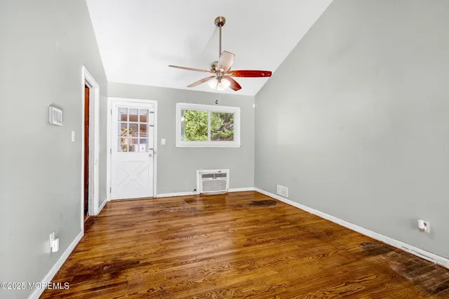 a view of room with a ceiling fan and window