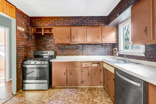 a kitchen with a sink stove and cabinets