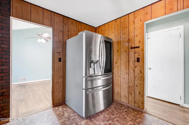 a metallic refrigerator freezer sitting in a kitchen