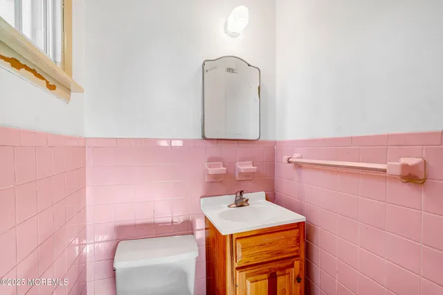 a bathroom with a sink a vanity and mirror
