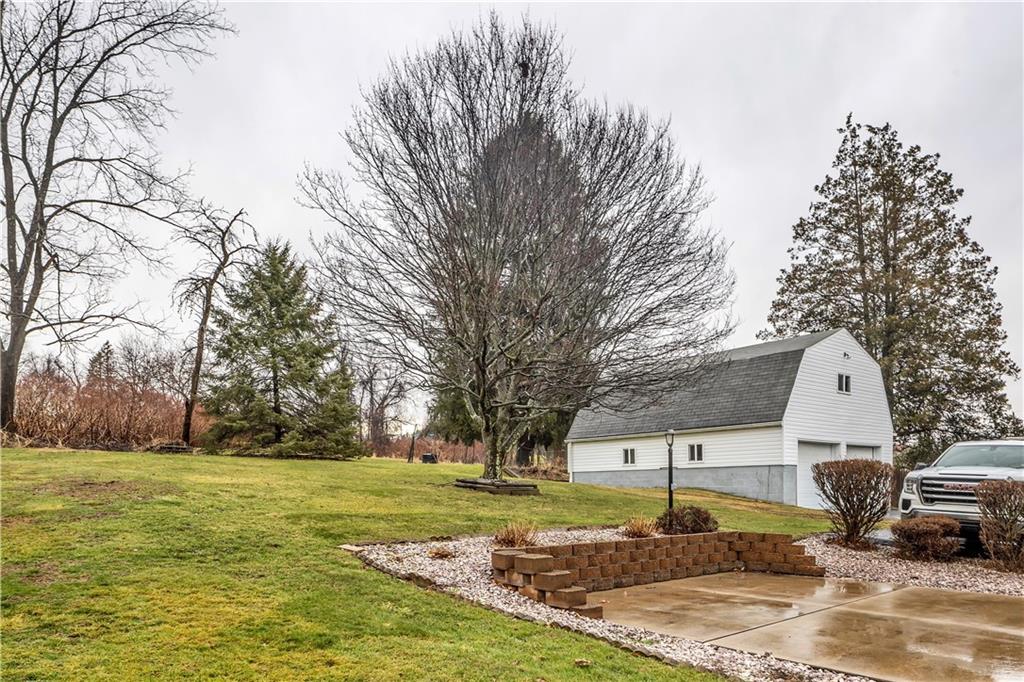 156 Manor Road Delmont, PA 15626 - Photo 5 of 32 Exterior Patio with Versa Loc Wall. Huge Detached 2 Car Garage with Loft Above.