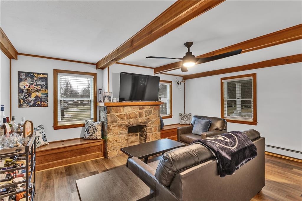 156 Manor Road Delmont, PA 15626 - Photo 6 of 32 13x17 Living or Dining Room with Beautiful Stone Fireplace Flanked by Windows and Window Seats.