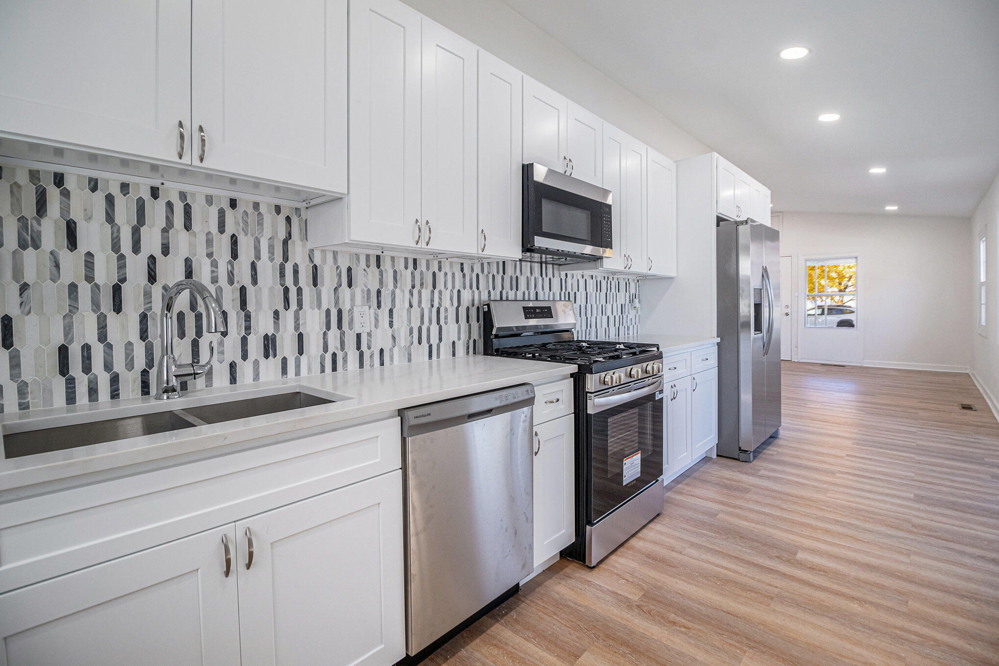 3336 175th Street Hammond, IN 46323 - Photo 4 of 14 a kitchen with stainless steel appliances granite countertop a stove a sink and a microwave
