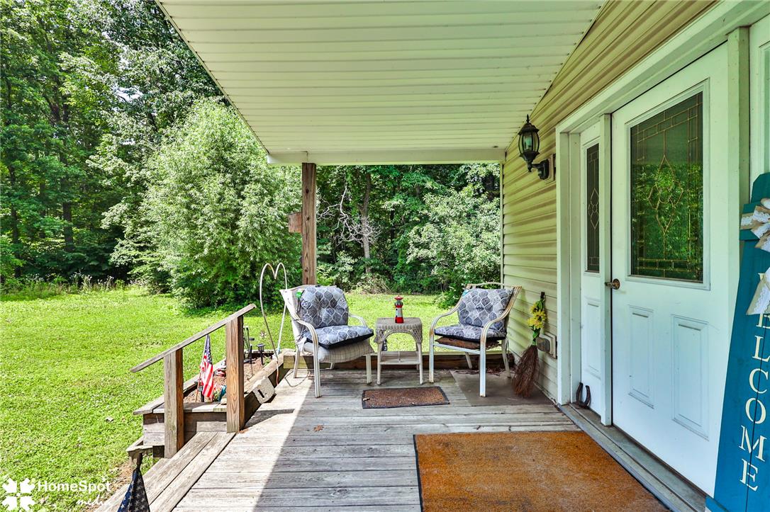 3795 Rhoades Road Kempton, PA 19529 - Photo 41 of 42 A tranquil covered porch invites relaxation with ample space for outdoor seating amidst a lush, private setting.