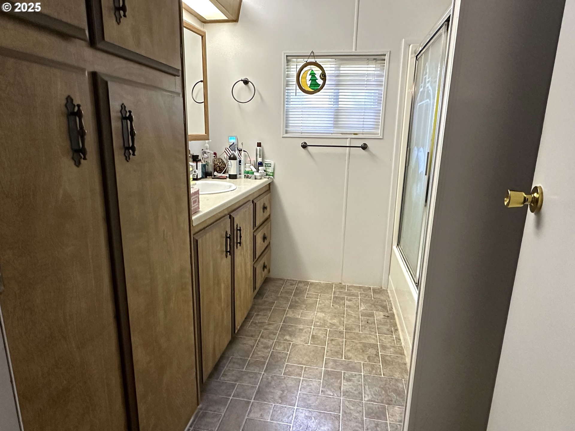 1601 Rhododendron Drive, Unit 572 Florence, OR 97439 - Photo 17 of 31 a bathroom with a sink a toilet and shower