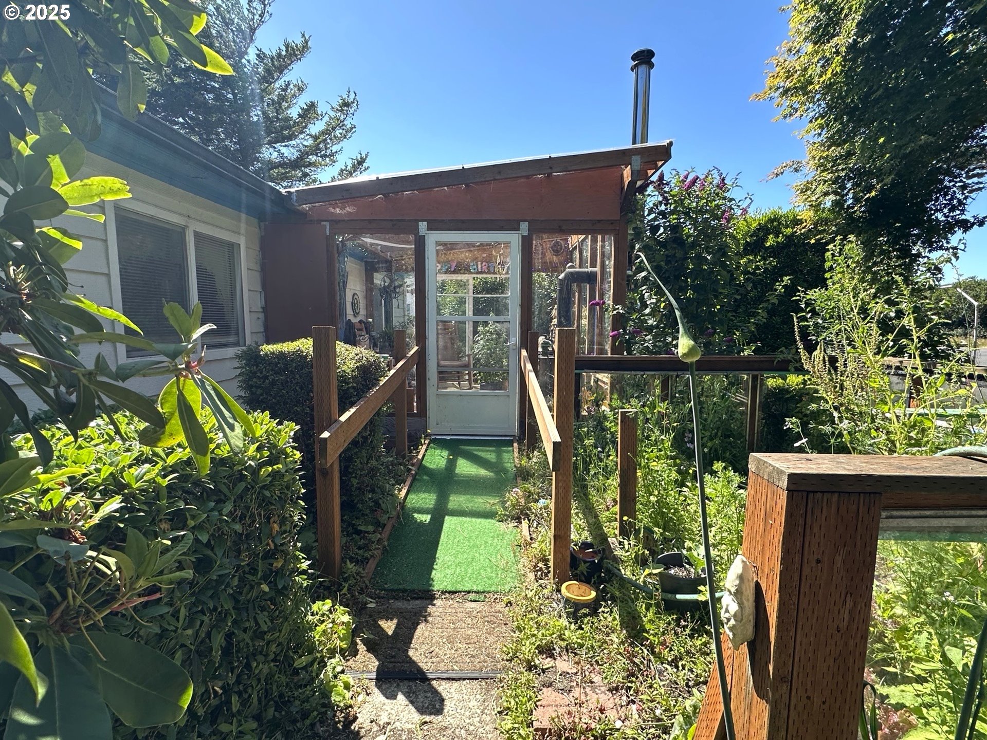 1601 Rhododendron Drive, Unit 572 Florence, OR 97439 - Photo 18 of 31 a front view of a house with garden