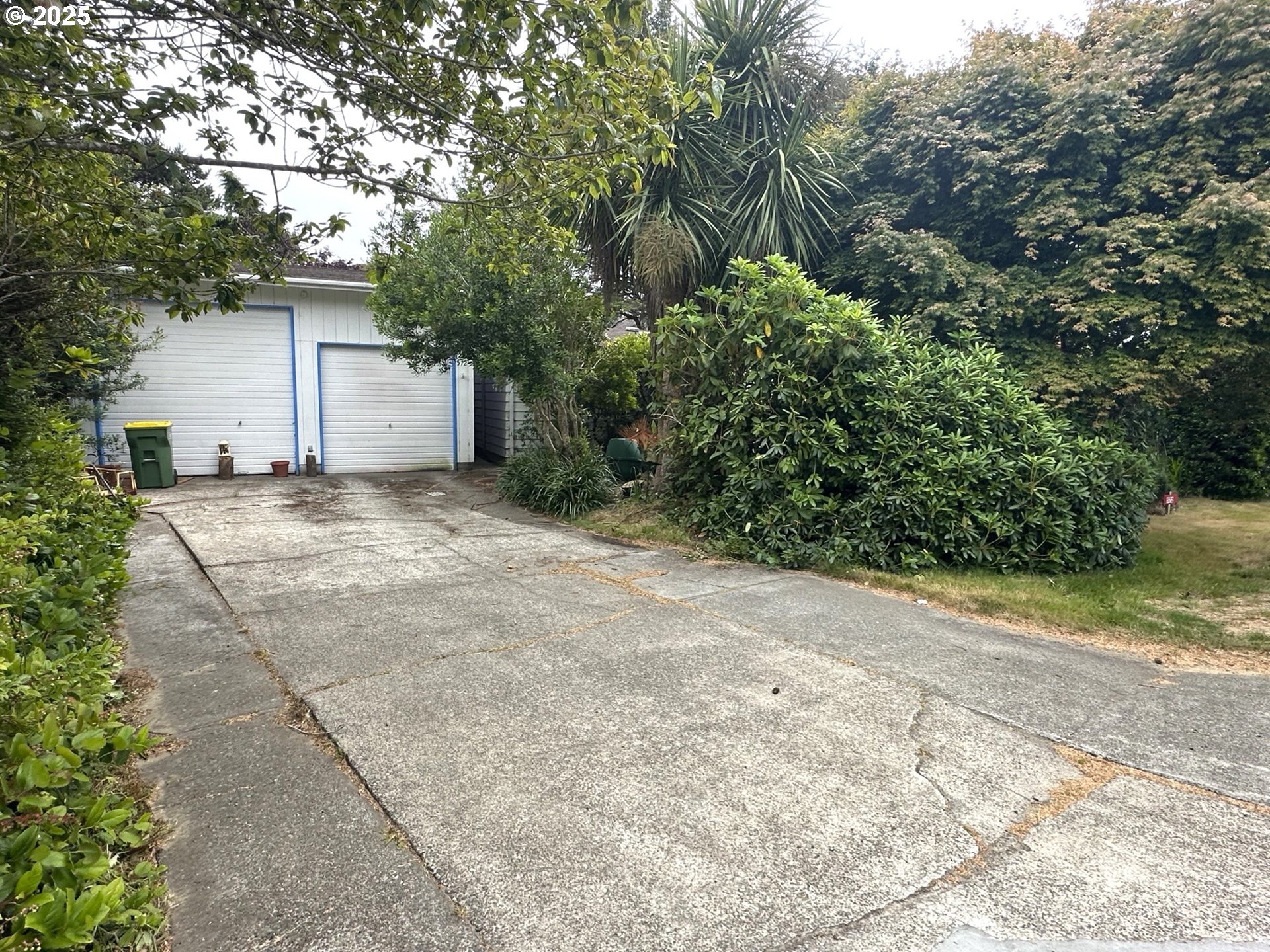 1601 Rhododendron Drive, Unit 572 Florence, OR 97439 - Photo 27 of 31 a view of a house with a yard and garage