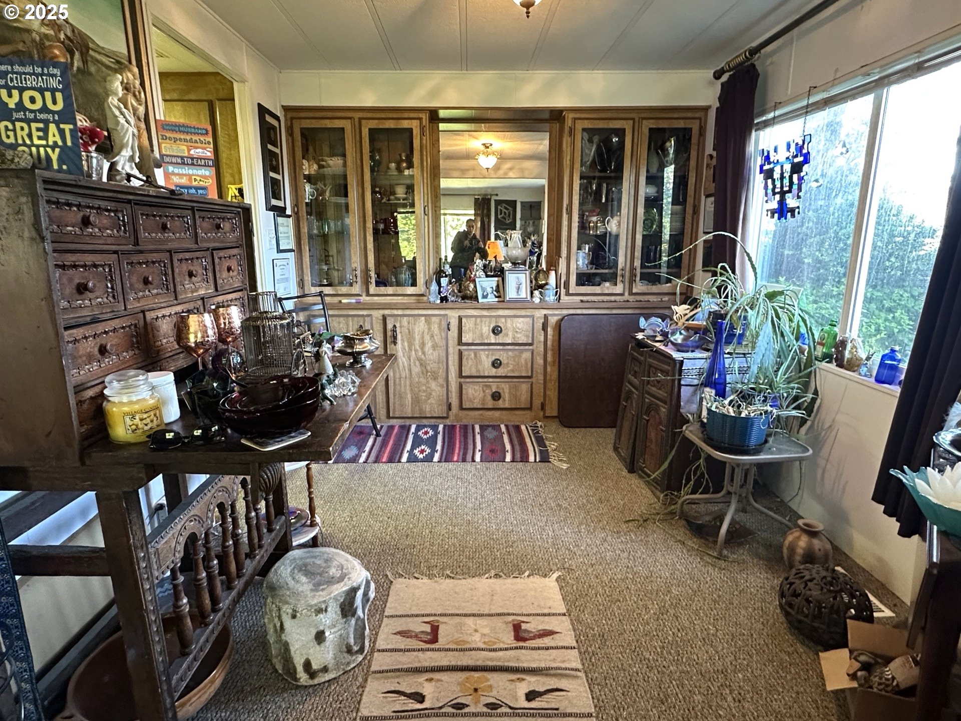 1601 Rhododendron Drive, Unit 572 Florence, OR 97439 - Photo 6 of 31 a room with lots of wooden furniture and a potted plant