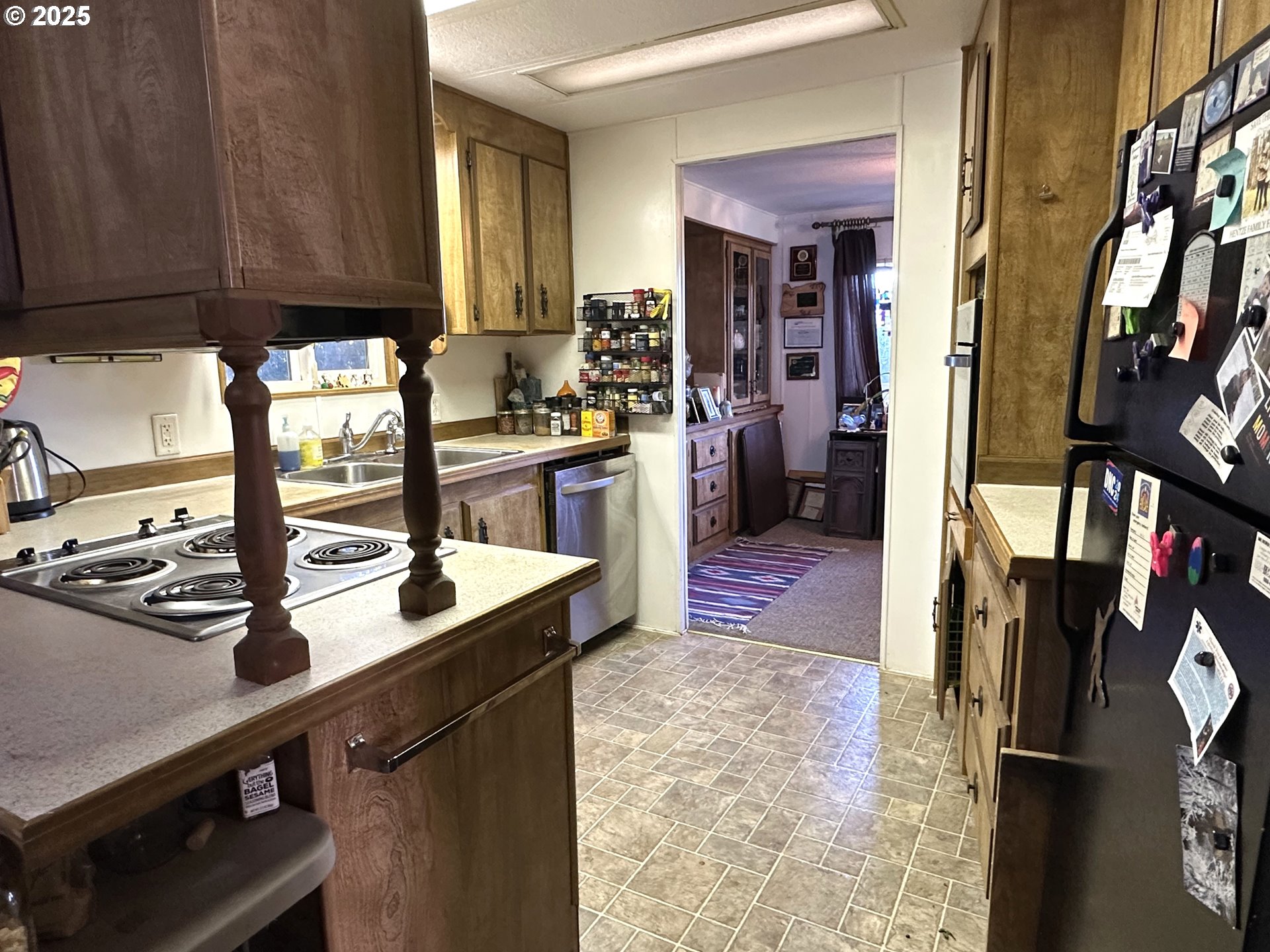 1601 Rhododendron Drive, Unit 572 Florence, OR 97439 - Photo 7 of 31 a kitchen with stainless steel appliances a sink stove and cabinets