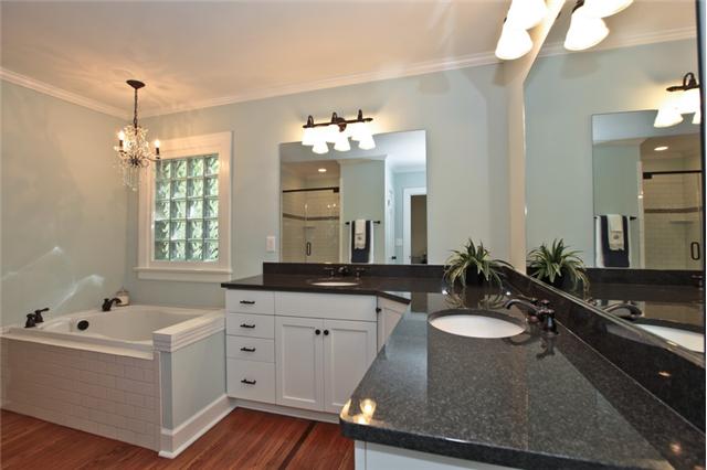 919 Sutton Hill Road Nashville, TN 37204 - Photo 11 of 20 This completely custom Master Bath is both functional and luxurious with a large soaking tub, separate vanities, walk-in shower with gorgeous tile, linen closet, and a separate toilet. Check out the beautiful chandelier!