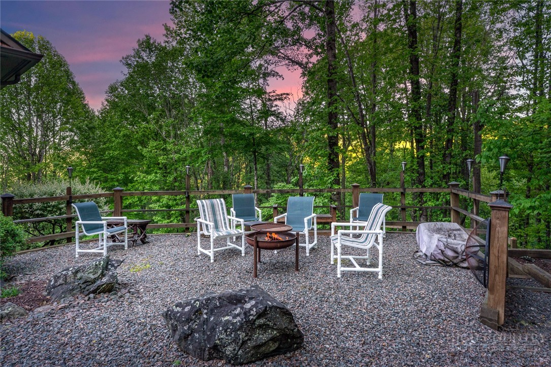171 Camp Davis Road Banner Elk, NC 28604 - Photo 13 of 48 a view of a chairs and table in backyard