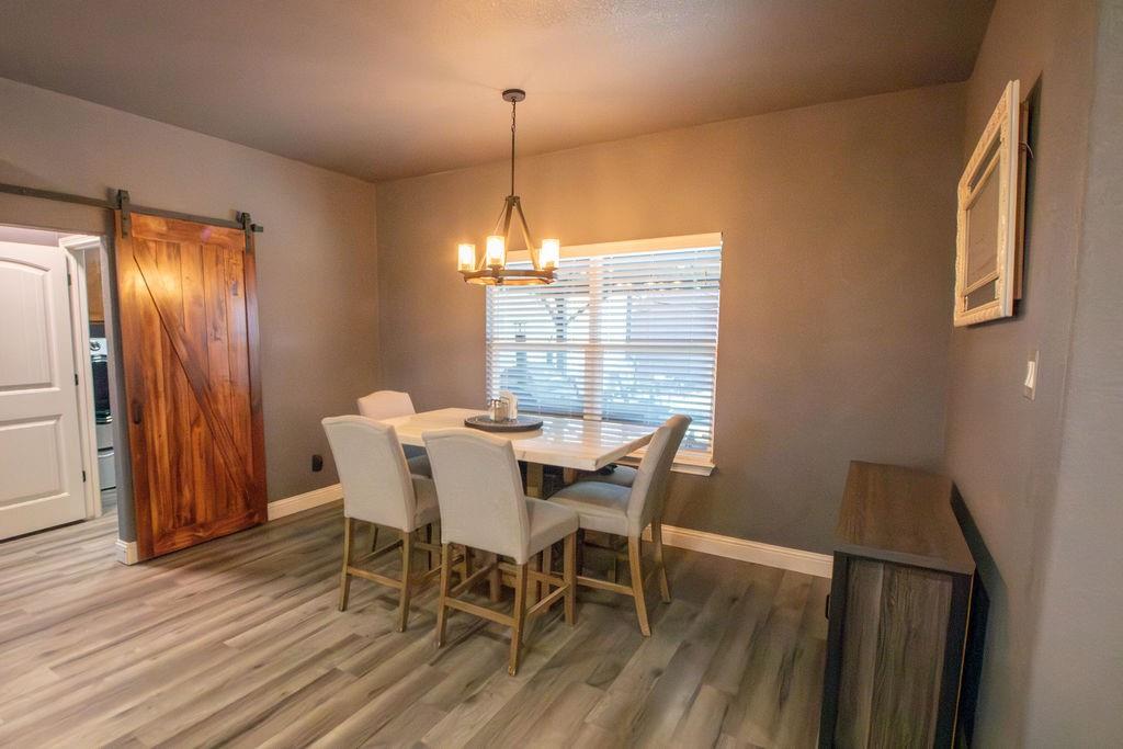 1144 Alamo Road Montague, TX 76251 - Photo 15 of 26 a view of a dining room with furniture window and wooden floor