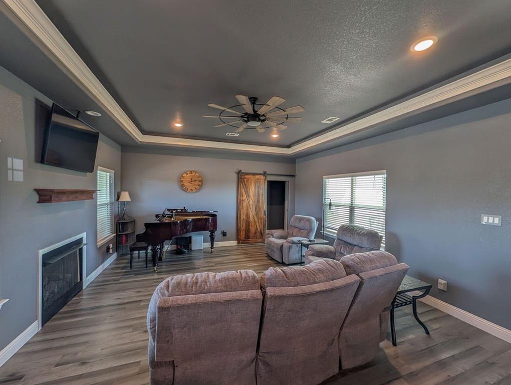1144 Alamo Road Montague, TX 76251 - Photo 17 of 26 a living room with fireplace furniture and a wooden floor