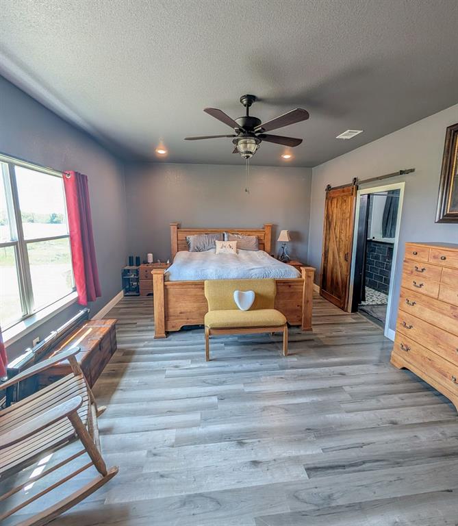 1144 Alamo Road Montague, TX 76251 - Photo 19 of 26 a living room with furniture and a flat screen tv
