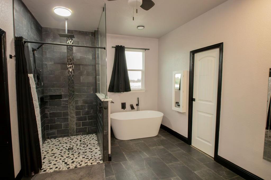 1144 Alamo Road Montague, TX 76251 - Photo 21 of 26 a bathroom with a sink a mirror and shower