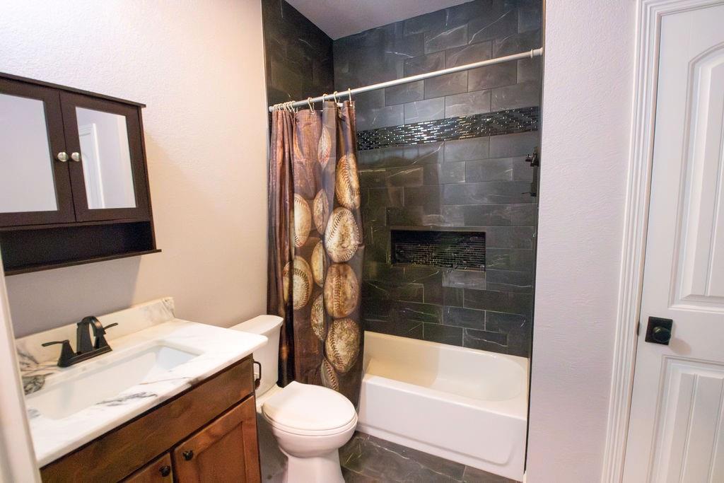 1144 Alamo Road Montague, TX 76251 - Photo 23 of 26 a bathroom with a sink and a mirror