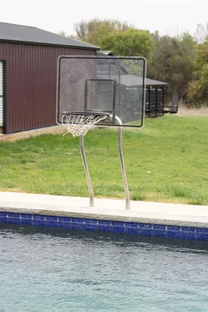 a view of a backyard with lawn chairs and plants