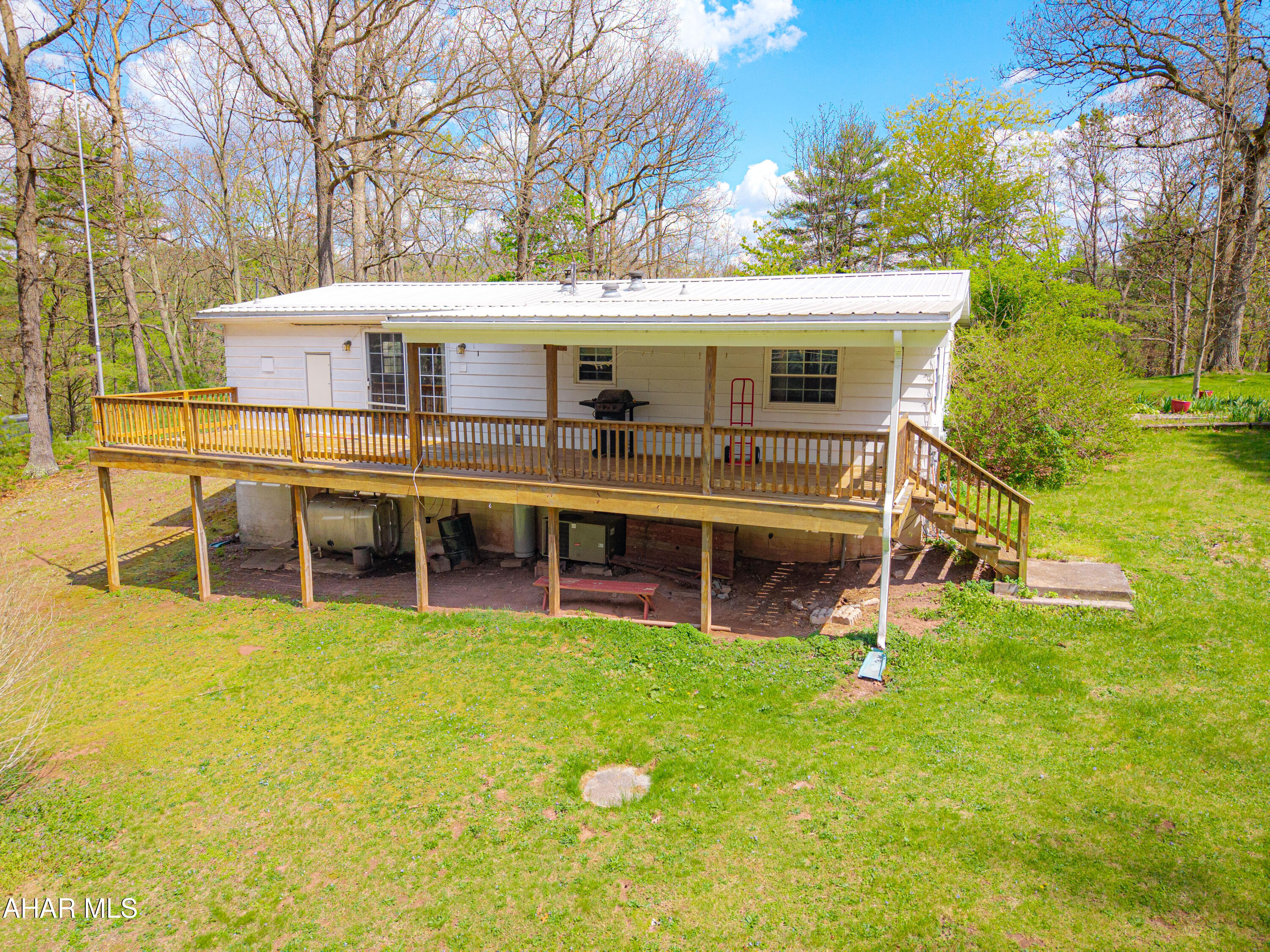 151 Pine Echo Road Everett, PA 15537 - Photo 6 of 51 a view of a house with a backyard and a tree