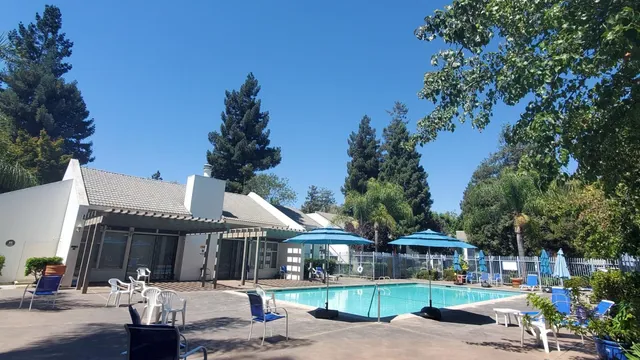 a front view of a house with garden and patio