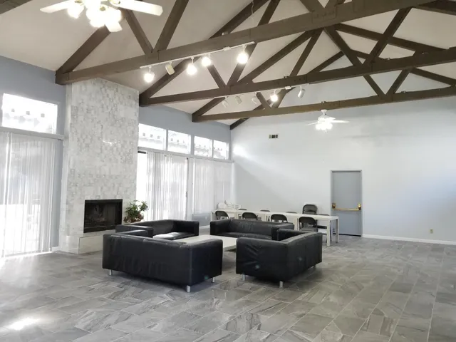 a living room with furniture and a fireplace