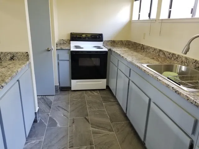a kitchen with a stove and a sink