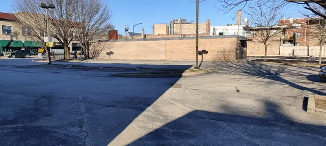 a view of a yard with wooden fence