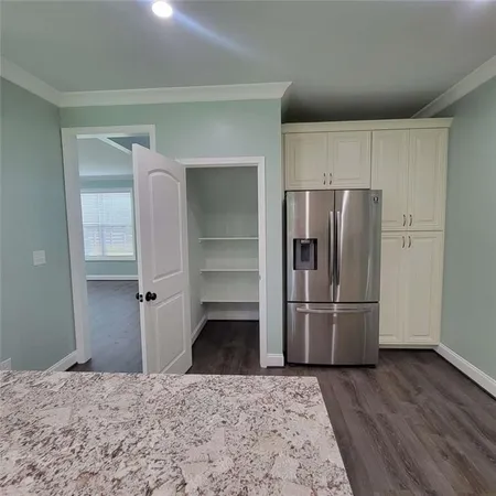 a kitchen with a refrigerator and a stove top oven