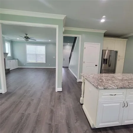 a kitchen with a sink microwave and cabinets