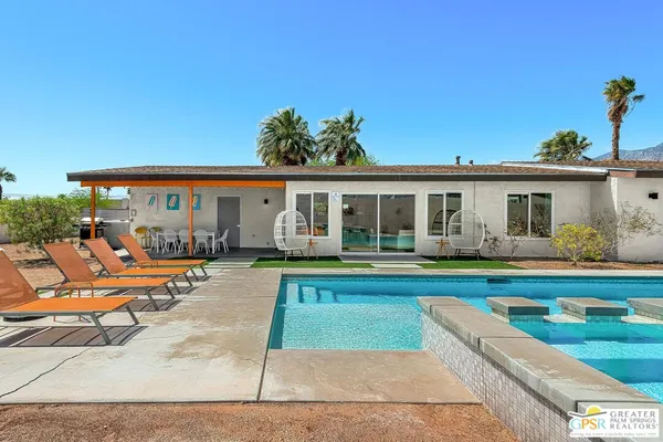 a view of swimming pool with lounge chair