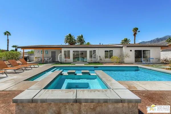 a house view with swimming pool and porch