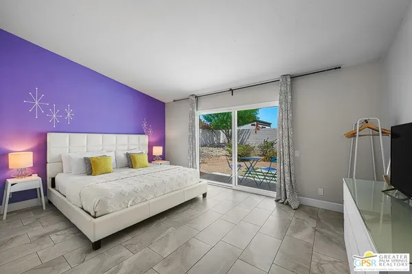 a bedroom with a large bed and a window