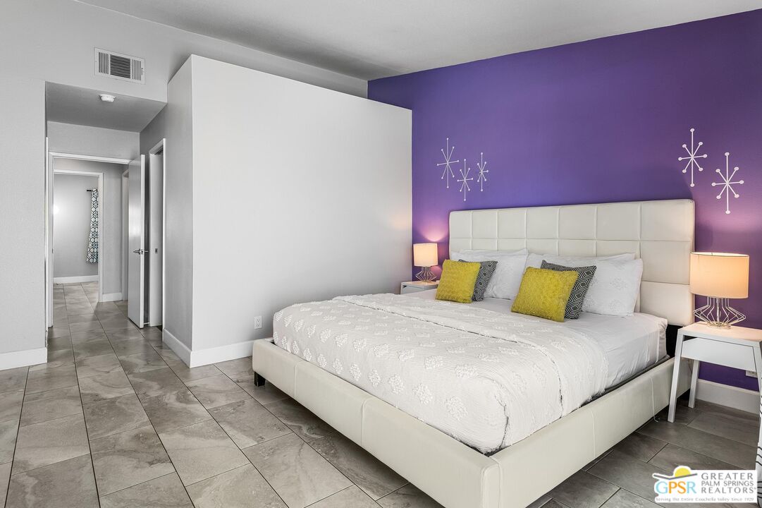 2864 East Valencia Road Palm Springs, CA 92262 - Photo 22 of 31 a bedroom with a bed and a lamp