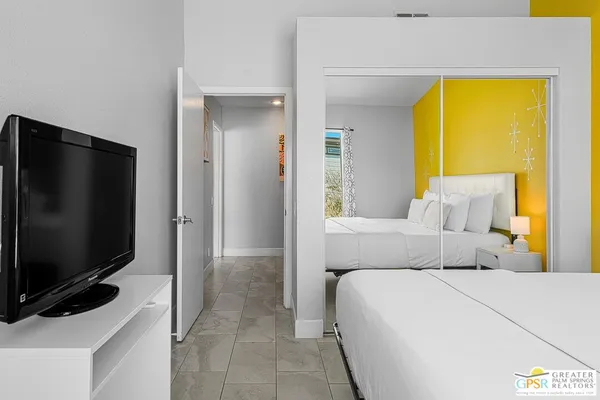 a bedroom with a bed and a television