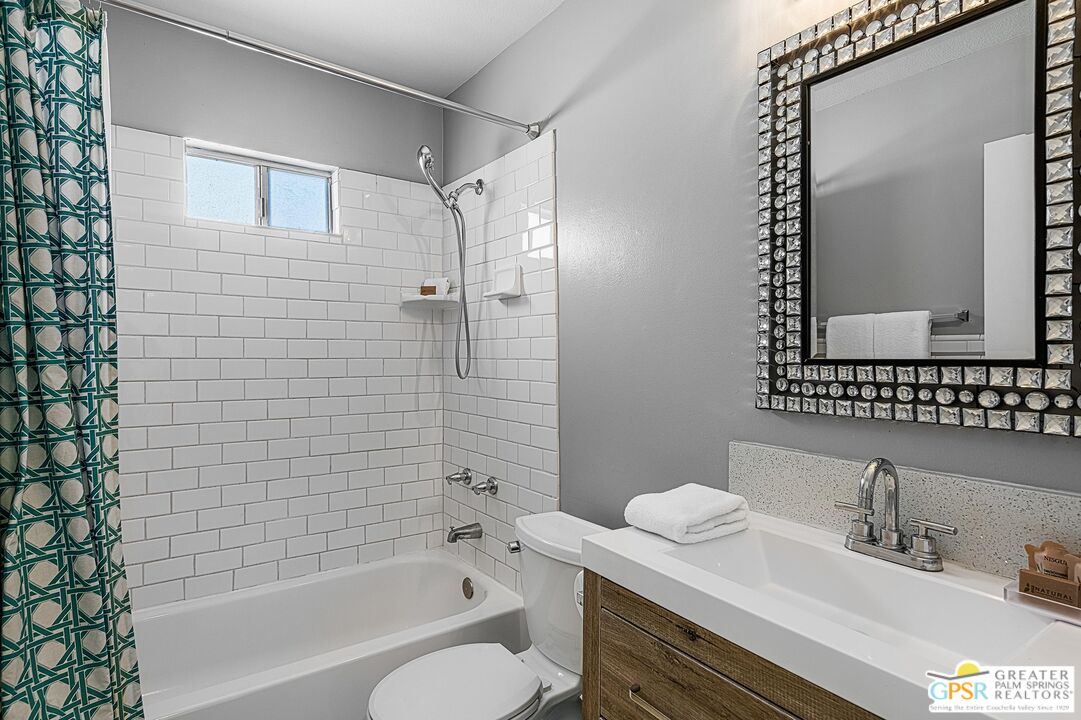 2864 East Valencia Road Palm Springs, CA 92262 - Photo 26 of 31 a bathroom with a granite countertop sink toilet and shower