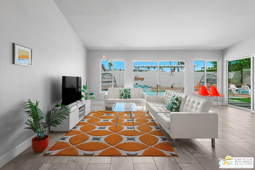 2864 East Valencia Road Palm Springs, CA 92262 - Photo 5 of 31 a living room with a couch and a flat screen tv