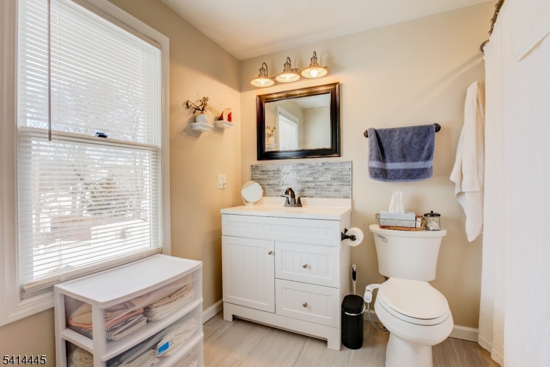 46 Walnut Street Pompton Lakes, NJ 07442 - Photo 14 of 22 a bathroom with a toilet sink and mirror