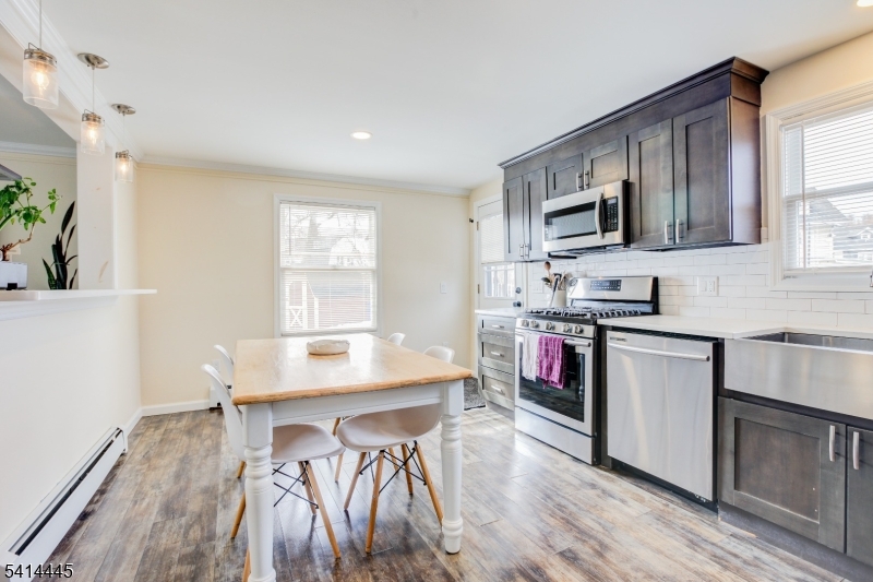 46 Walnut Street Pompton Lakes, NJ 07442 - Photo 7 of 22 a kitchen with stainless steel appliances a microwave a stove a sink a microwave and a refrigerator