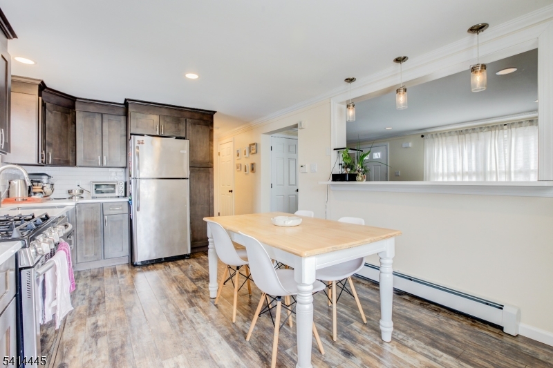 46 Walnut Street Pompton Lakes, NJ 07442 - Photo 9 of 22 a kitchen with white cabinets and refrigerator