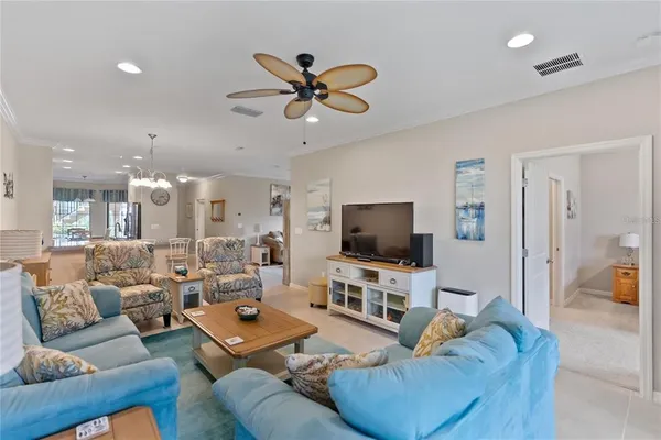 a living room with furniture ceiling fan and a rug