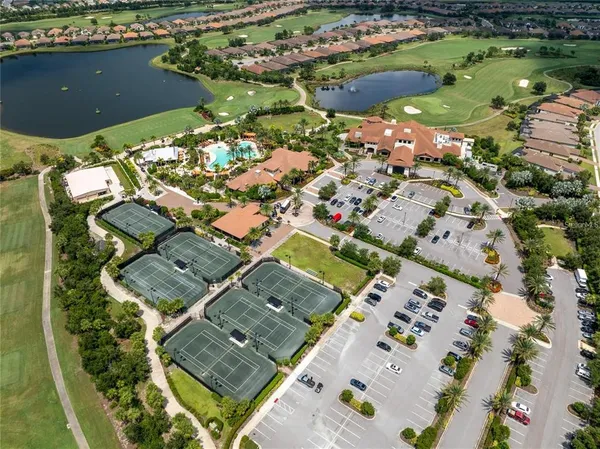 an aerial view of residential houses with outdoor space and trees