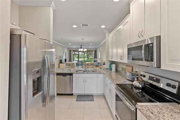 a kitchen with stainless steel appliances a sink stove and refrigerator