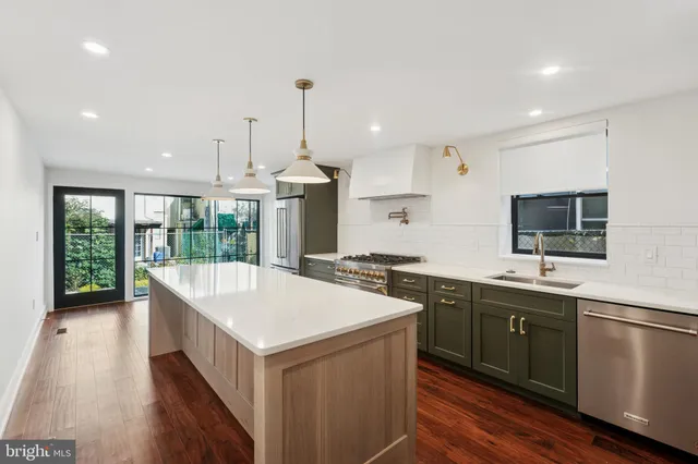 a kitchen with a sink and wooden floor