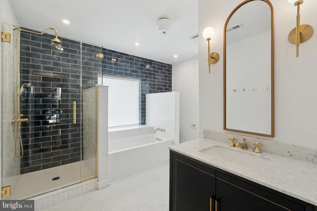 a bathroom with a shower sink and mirror