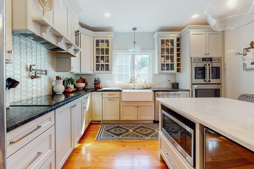 185 Bailey Street Canton, MA 02021 - Photo 6 of 32 a kitchen with a sink stove and cabinets